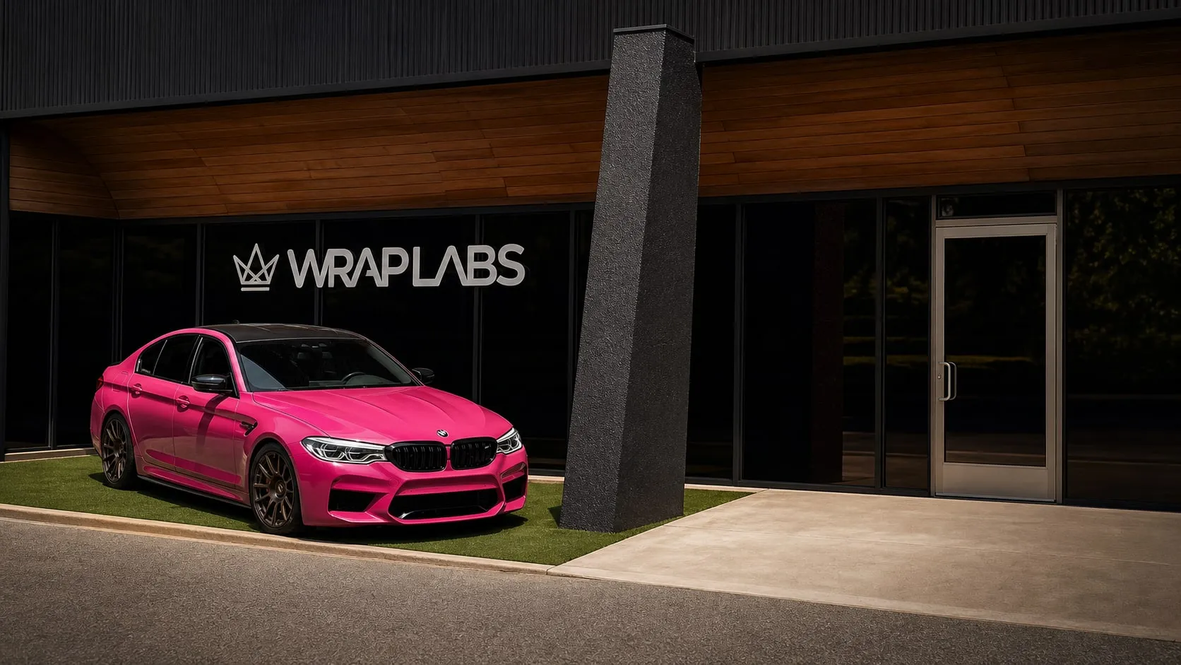 Pink-wrapped BMW M5 Competition parked outside the Wrap Labs storefront in Westlake Village