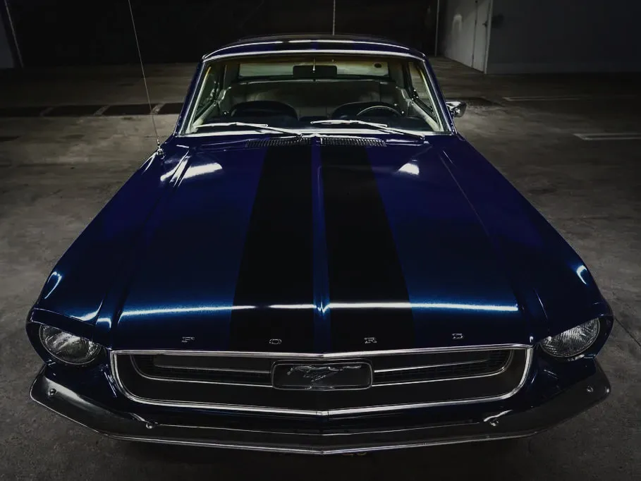 Black racing stripes on a blue classic Mustang