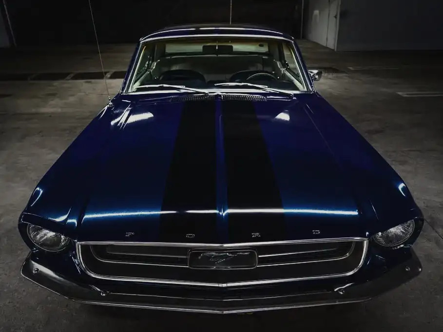 Black racing stripes on a blue classic Mustang