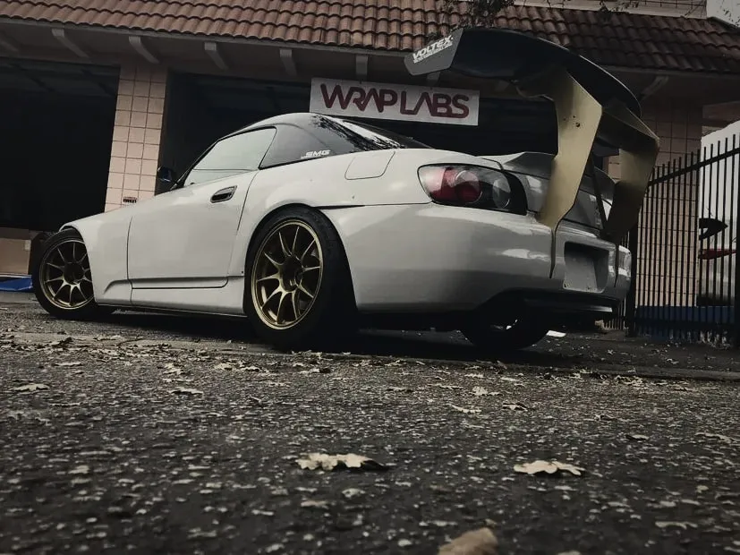 Honda S2000 with a large aftermarket rear wing, outside the Wrap Labs studio