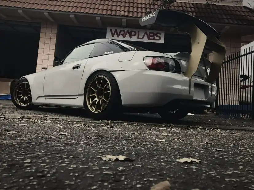 Honda S2000 with a large aftermarket rear wing, outside the Wrap Labs studio