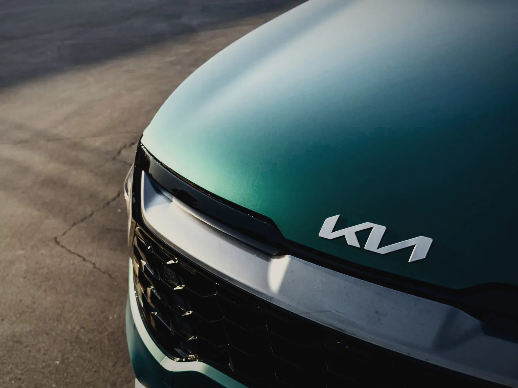 Teal color protection film across the hood of a Kia Sportage
