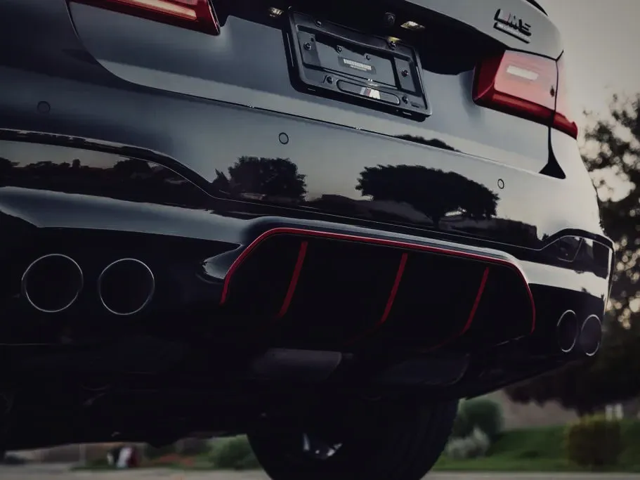 Quad exhaust tips and rear diffuser of a black BMW M5