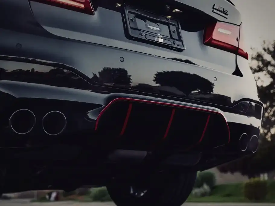 Quad exhaust tips and rear diffuser of a black BMW M5
