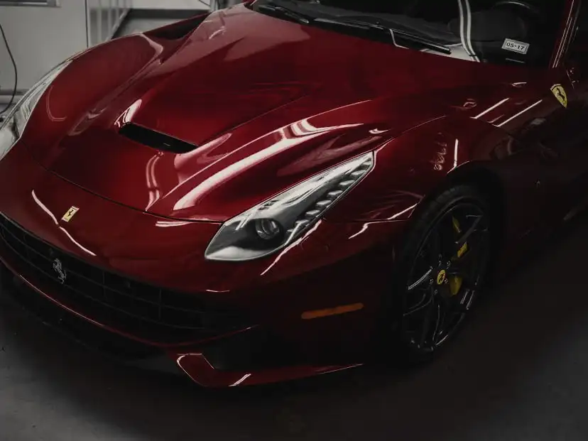 Paint protection film on the front end of a red Ferrari F12 in the Wrap Labs studio