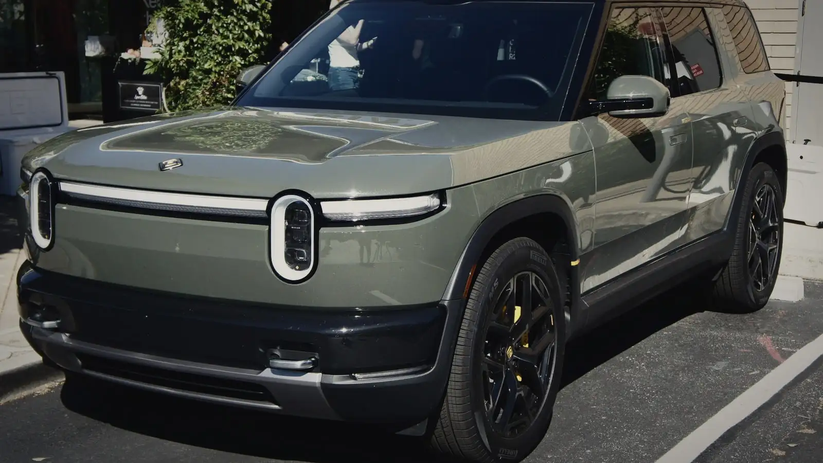 Rivian R2 in a sage green finish, front three-quarter view