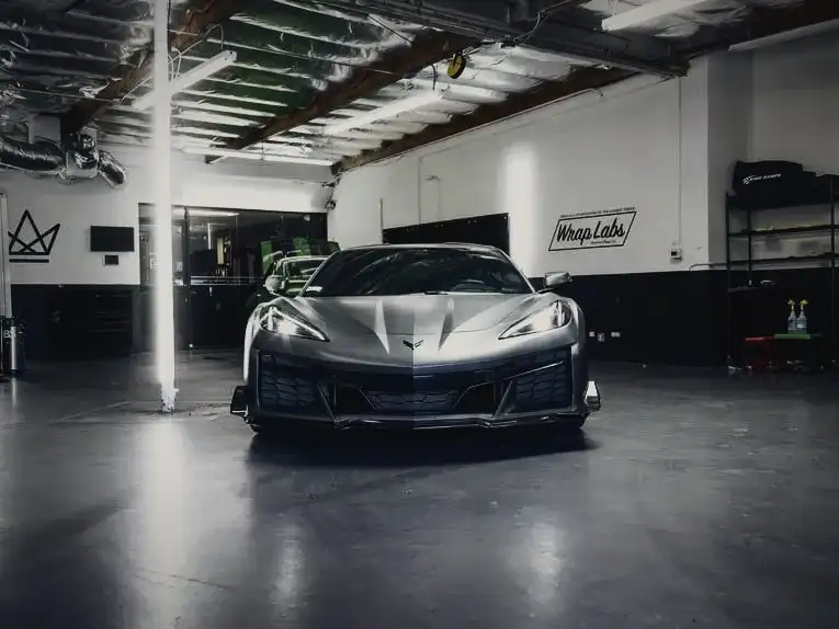 Windshield and low front splitter of a Corvette Z06, head-on in the Wrap Labs bay