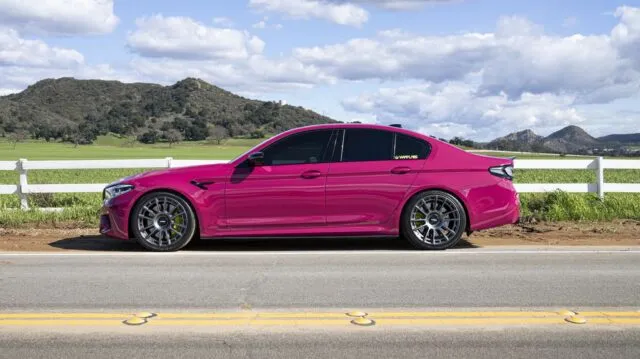 BMW M5 Fuchsia Pink Vinyl Wrap Side Profile Farmland Mountains
