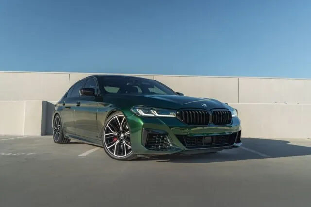 BMW M5 Gloss Green Vinyl Wrap Front 3 4 Parking Structure