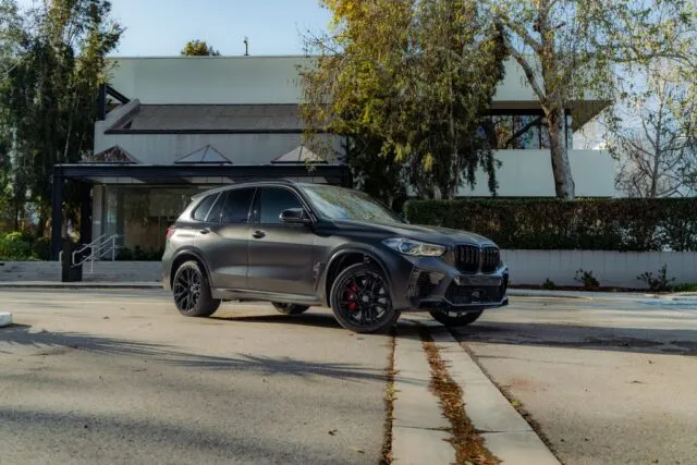 BMW X5 M Competition Matte Black Vinyl Wrap Front Three Quarter Street
