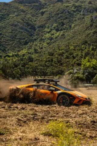 Lamborghini Huracan Sterrato Orange Vinyl Wrap Side Action Dirt Roost Mountain 2