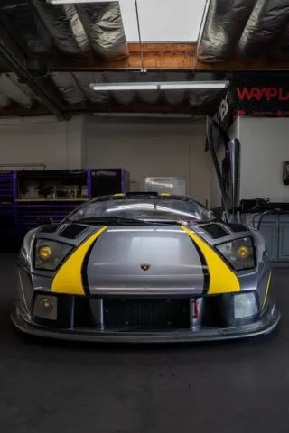 Lamborghini Murcielago Race Car Matte Grey Yellow Stripes Vinyl Wrap Front Head On WrapLabs Shop, by Wrap Labs, Westlake Village