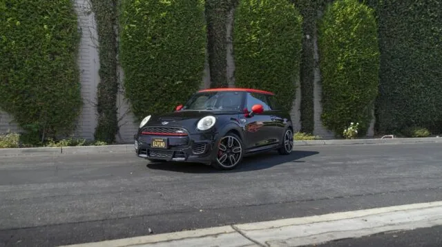 MINI Cooper JCW Black Red Roof Mirror Vinyl Wrap Front 3Quarter Hedge Wall