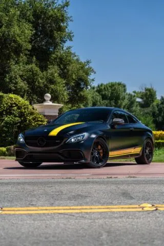 Mercedes AMG C63 S Matte Black Yellow Stripe Vinyl Wrap Front 3Quarter Street Trees