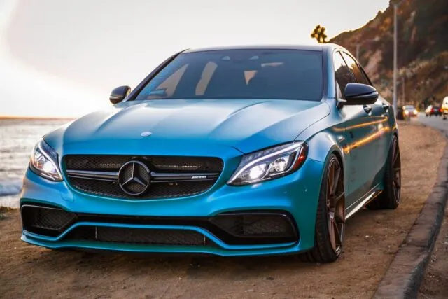 Mercedes AMG C63 Teal Blue Vinyl Wrap Front Oceanside Sunset