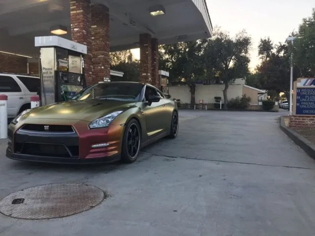 Nissan GT R Color Shift Gold Red Vinyl Wrap Front Three Quarter Gas Station