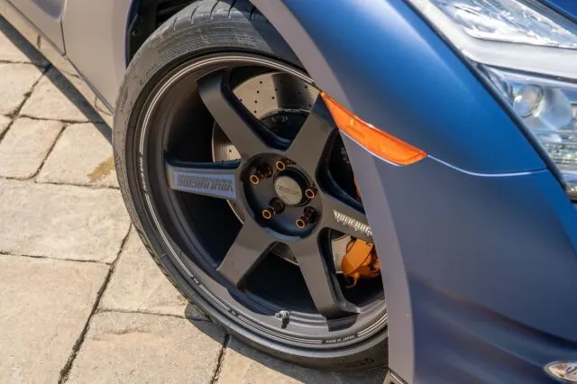 Nissan GT R R35 Matte Blue Vinyl Wrap Volk Racing Wheel Orange Caliper Closeup v2