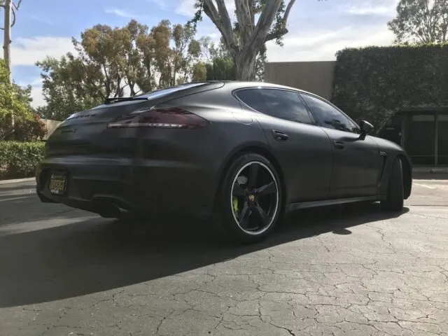 Porsche Panamera Turbo Matte Black Vinyl Wrap Rear Three Quarter Parking Lot