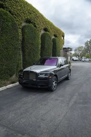 Rolls Royce Cullinan Black Silver Two Tone Purple Interior CPF Front 3Quarter Ivy Wall