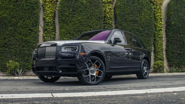 Rolls Royce Cullinan Black Silver Two Tone Purple Interior CPF Front 3Quarter Street Trees