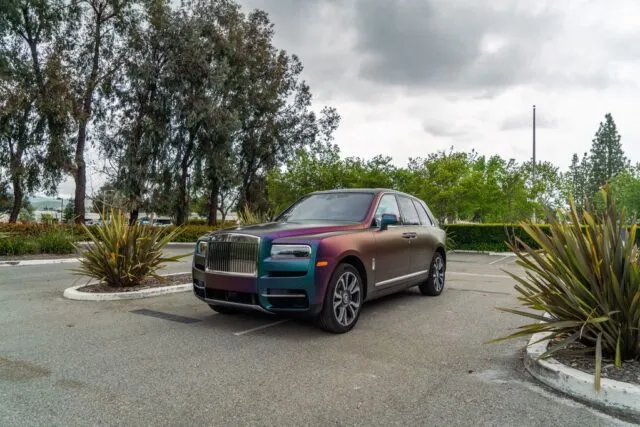 Rolls Royce Cullinan Color Shift Chameleon Vinyl Wrap Front 3Quarter Parking Lot Plants