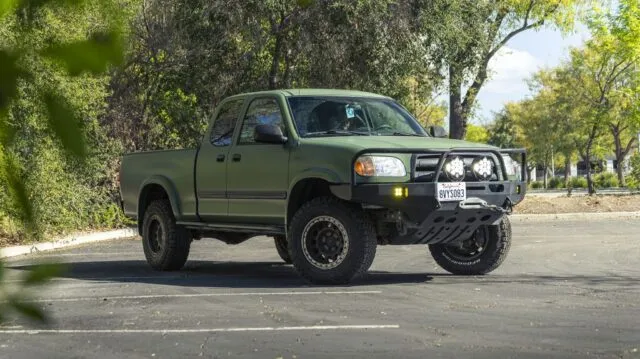 Toyota Tundra Matte Military Green Vinyl Wrap Front 3Quarter Through Foliage