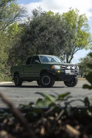 Toyota Tundra Matte Military Green Vinyl Wrap Front Vertical Through Foliage