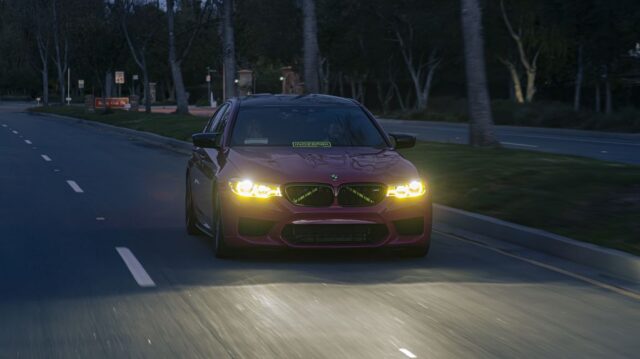 BMW M5 F90 Pink Vinyl Wrap Driving Night Shot Front, by Wrap Labs, Westlake Village