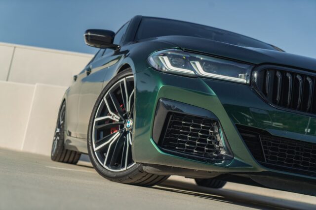 BMW M5 Gloss Green Vinyl Wrap Front Wheel Headlight Closeup, by Wrap Labs, Westlake Village