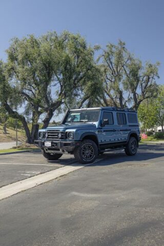 INEOS Grenadier Steel Blue PPF Front 3Quarter Vertical Parking Lot Trees, by Wrap Labs, Westlake Village