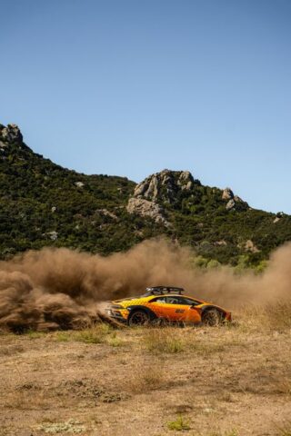 Lamborghini Huracan Sterrato Orange Vinyl Wrap Side Action Dust Wide Mountain, by Wrap Labs, Westlake Village