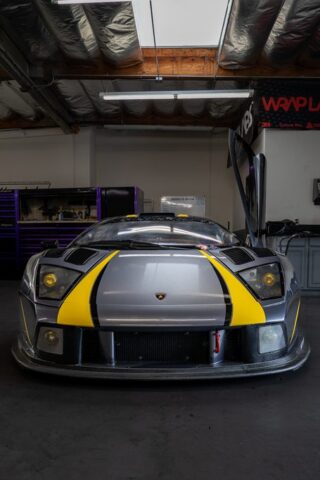 Lamborghini Murcielago Race Car Matte Grey Yellow Stripes Vinyl Wrap Front Head On WrapLabs Shop, by Wrap Labs, Westlake Village