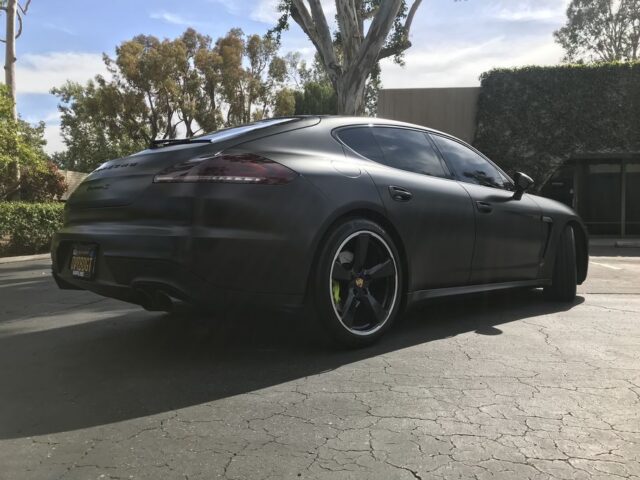 Porsche Panamera Turbo Matte Black Vinyl Wrap Rear Three Quarter Parking Lot, by Wrap Labs, Westlake Village