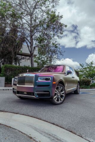 Rolls Royce Cullinan Color Shift Chameleon Vinyl Wrap Front 3Quarter Vertical Street Trees, by Wrap Labs, Westlake Village