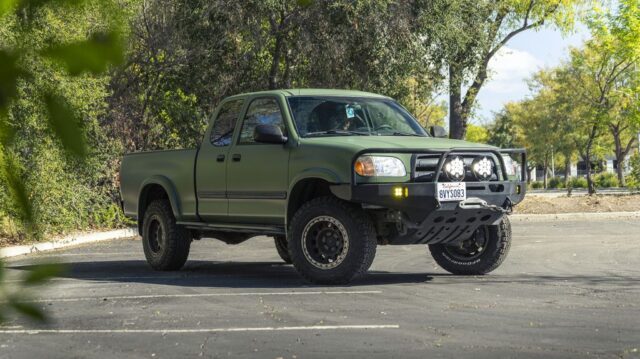 Toyota Tundra Matte Military Green Vinyl Wrap Front 3Quarter Through Foliage, by Wrap Labs, Westlake Village