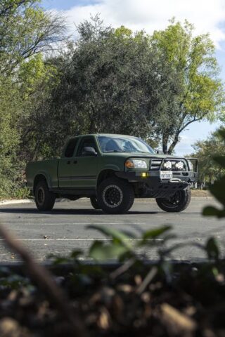 Toyota Tundra Matte Military Green Vinyl Wrap Front Vertical Through Foliage, by Wrap Labs, Westlake Village